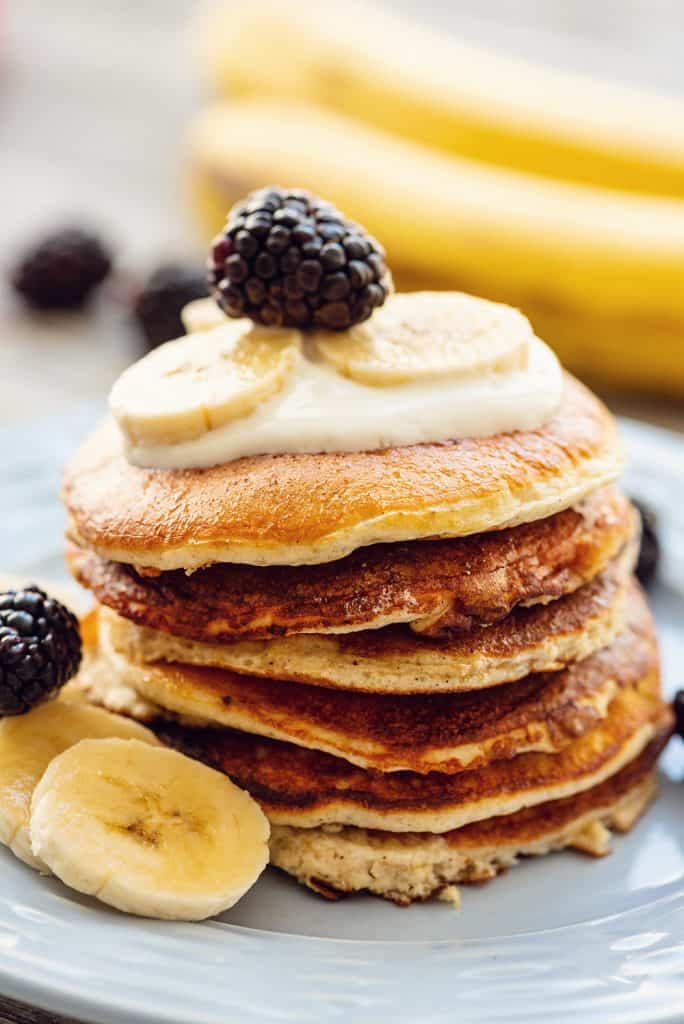 Light & Fluffy Banana Protein Pancakes stack with fruit